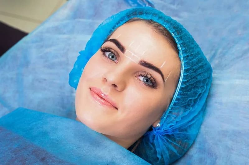 Brow mapping marks on a client during a cosmetic tattoo appointment