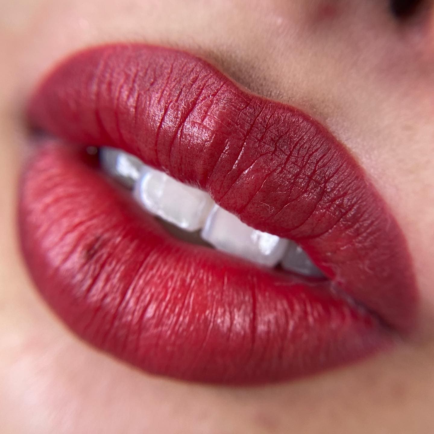 Close-up of a saturated red lip blush result